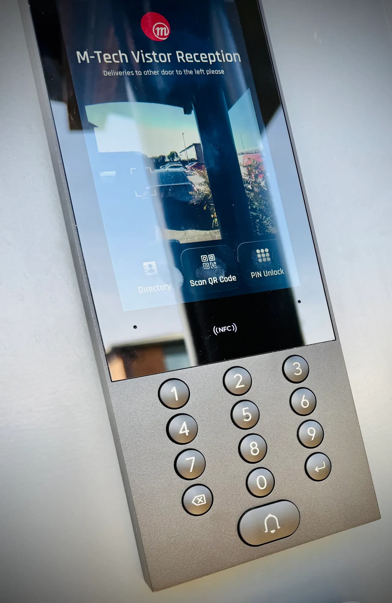 UniFi Access intercom at M-Tech's reception with NFC reader and keypad