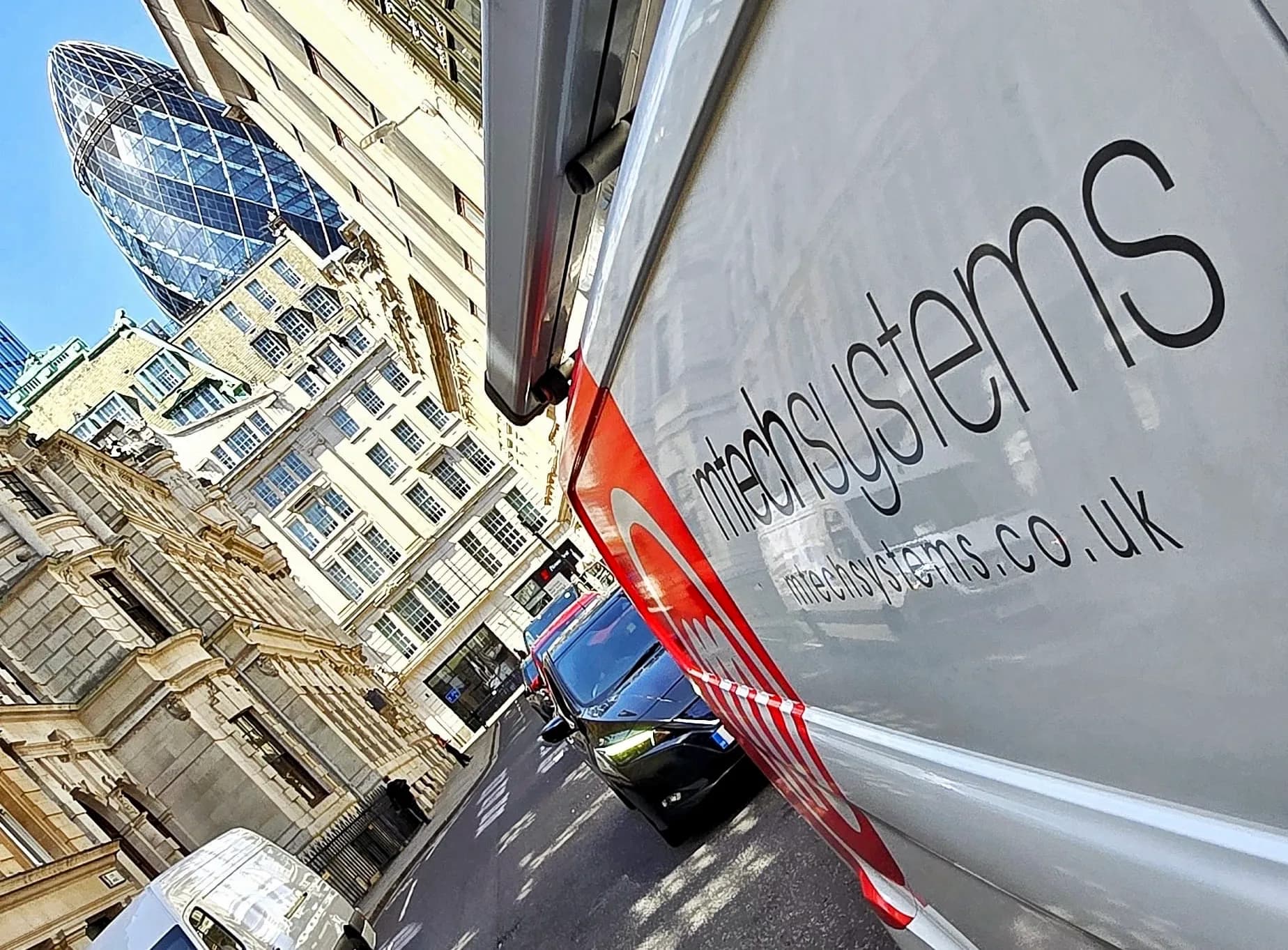 M-Tech Systems van in the City of London with the Gherkin behind