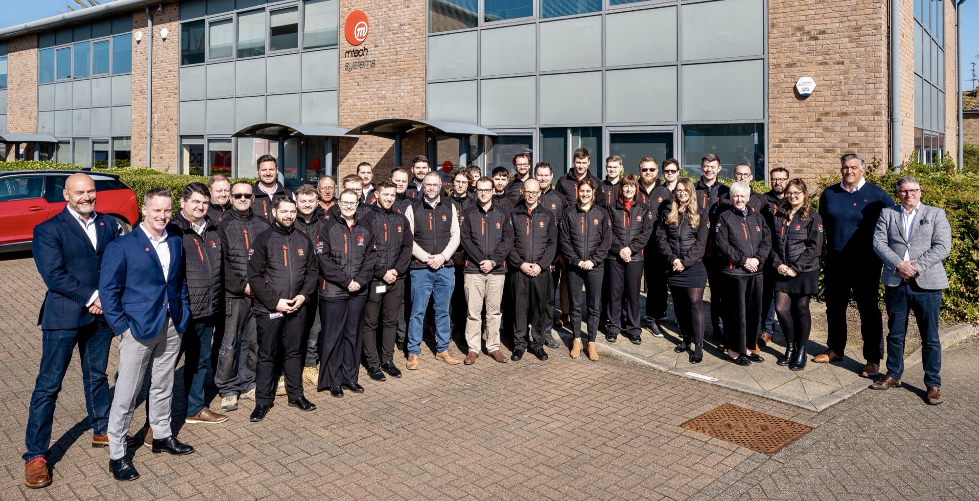 The M-Tech Systems team gathered outside the Eastbourne office, 2023